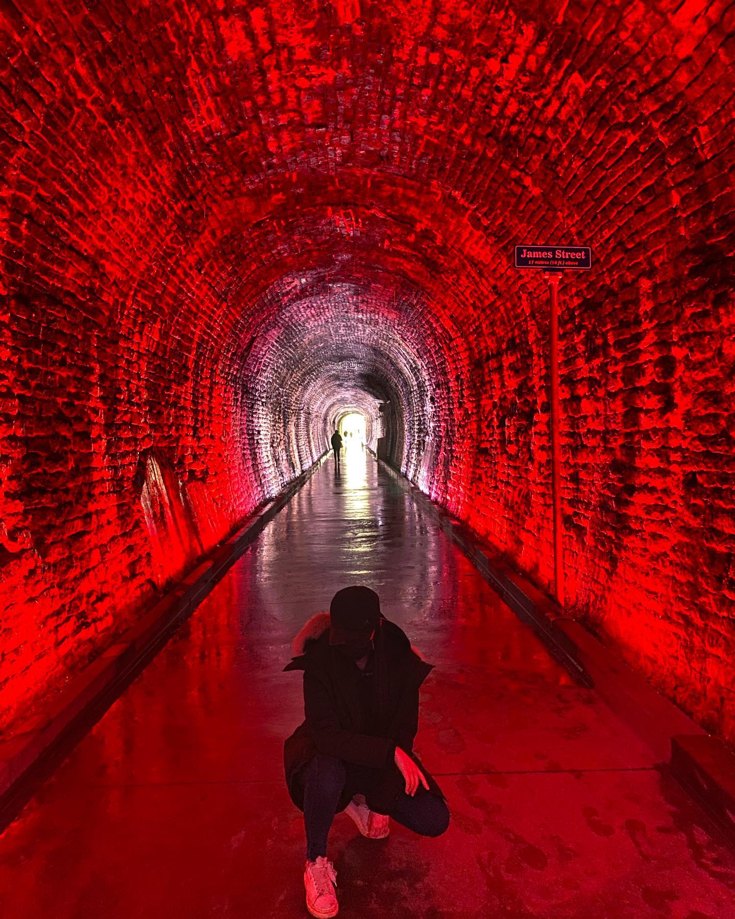 Iris in a red-lit railway tunnel